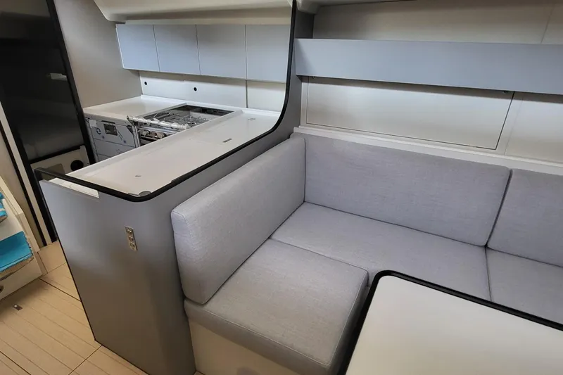 Slide: The Image of Modern interior of 2026 Italia Yachts 12.98, featuring sleek kitchen and cozy seating area. - 6