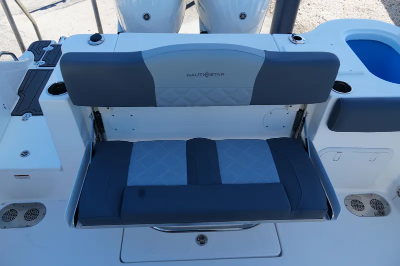 Slide: The Image of 2025 NauticStar 292 Legacy boat seating with dual engines and modern design. - 11