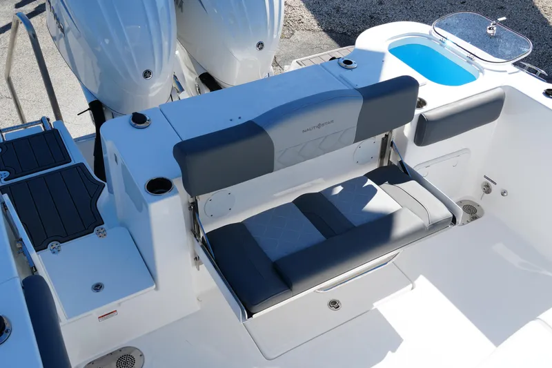 Slide: The Image of 2025 NauticStar 292 Legacy boat interior with seating and dual outboard motors. - 7