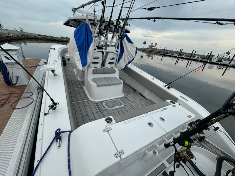 Slide: The Image of 2017 Cape Horn 36 XS fishing boat docked, equipped with multiple fishing rods. - 13