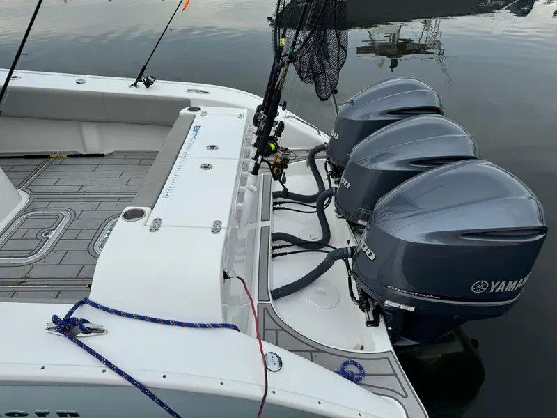 Slide: The Image of 2017 Cape Horn 36 XS boat with triple Yamaha outboard engines, docked on calm water. - 3