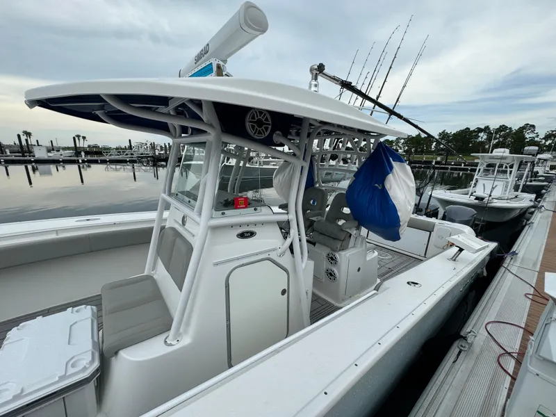 Slide: The Image of 2017 Cape Horn 36 XS boat docked, featuring a spacious deck and fishing equipment. - 6