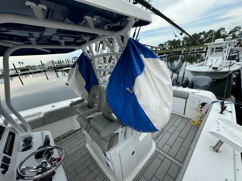 Slide: The Image of 2017 Cape Horn 36 XS boat interior with seating and steering wheel at marina. - 8