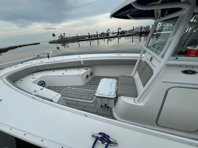 Slide: The Image of 2017 Cape Horn 36 XS boat, spacious deck, calm marina backdrop. - 9
