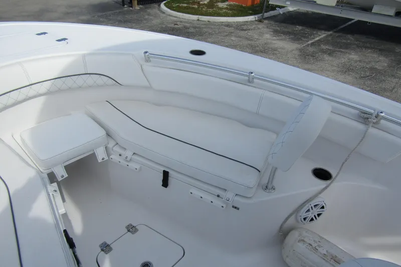Slide: The Image of 2023 Sportsman Open 212 Center Console boat interior with white seating and storage compartments. - 10