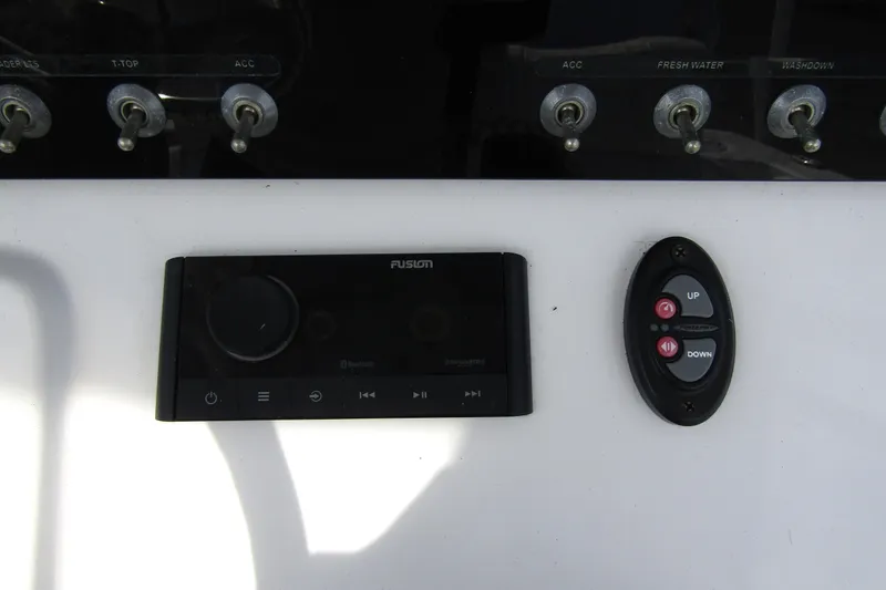 Slide: The Image of Control panel of 2023 Sportsman Open 212 Center Console with switches and audio system. - 23