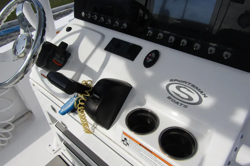 Slide: The Image of 2023 Sportsman Open 212 Center Console dashboard with steering wheel and controls. - 24
