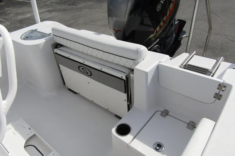 Slide: The Image of 2023 Sportsman Open 212 Center Console boat interior with seating and engine view. - 28