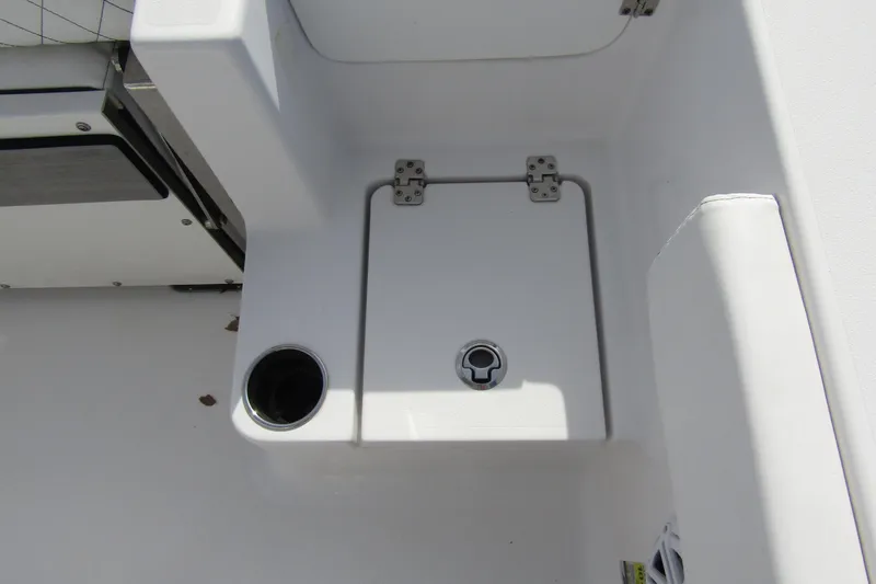 Slide: The Image of 2023 Sportsman Open 212 Center Console boat storage compartment with cup holder. - 30