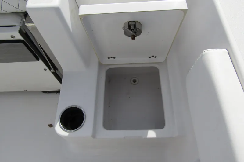 Slide: The Image of 2023 Sportsman Open 212 Center Console boat sink and cup holder detail. - 31