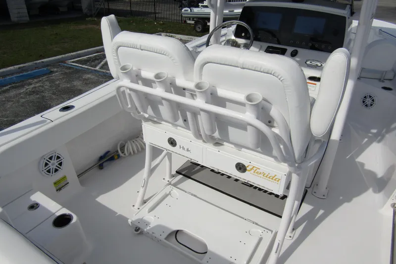 Slide: The Image of 2023 Sportsman Open 212 Center Console boat interior with white seating and control panel. - 34