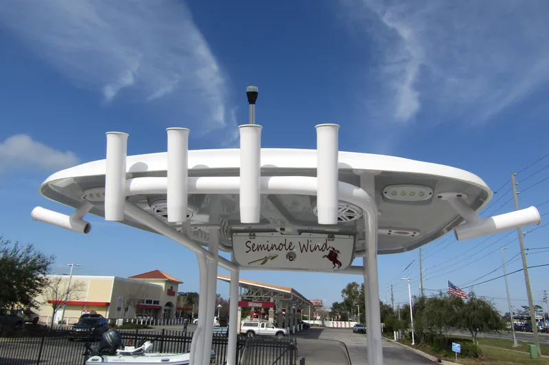 Slide: The Image of 2023 Sportsman Open 212 Center Console boat with T-top and rod holders. - 35