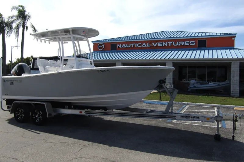 Slide: The Image of 2023 Sportsman Open 212 Center Console boat on trailer at Nautical Ventures dealership. - 6