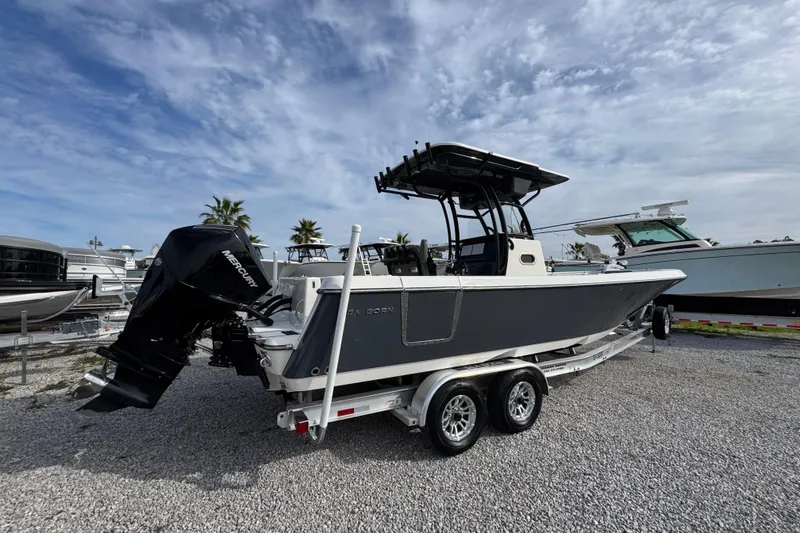 Slide: The Image of 2021 Sea Born LX26 Center Console boat on trailer, featuring Mercury outboard engine. - 10