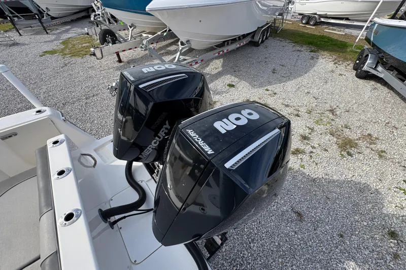 Slide: The Image of 2021 Sea Born LX26 Center Console with twin Mercury outboard engines in a boatyard. - 16