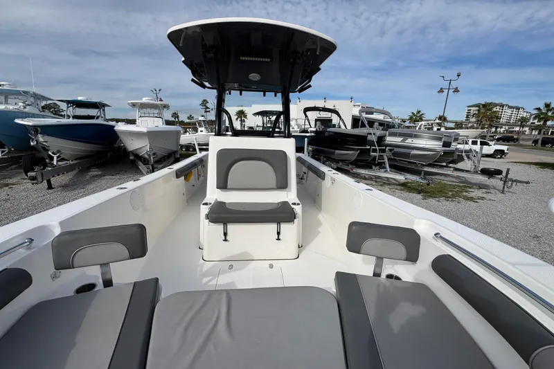 Slide: The Image of 2021 Sea Born LX26 Center Console boat with seating, displayed in a marina. - 24