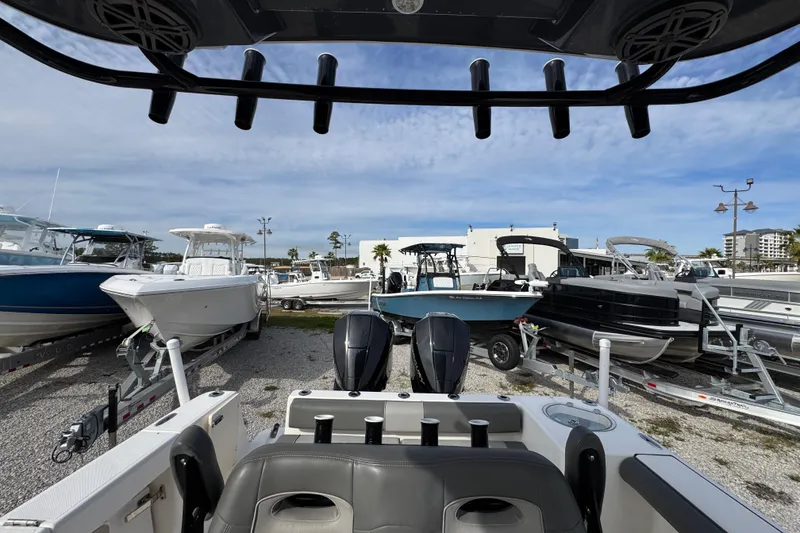 Slide: The Image of 2021 Sea Born LX26 Center Console boat in a marina with other vessels. - 28