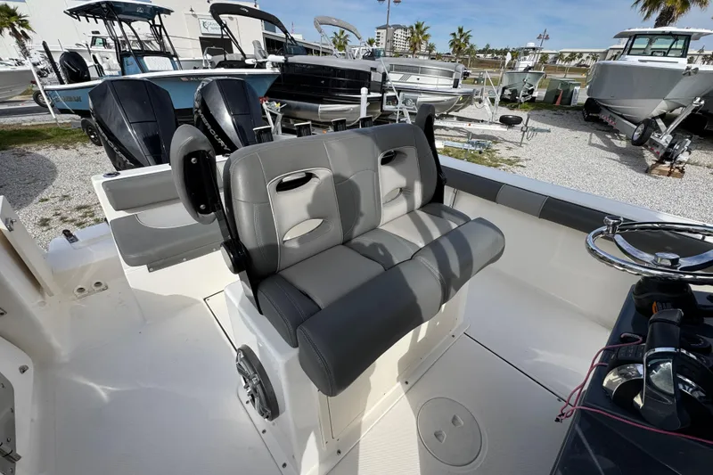 Slide: The Image of 2021 Sea Born LX26 Center Console boat interior with dual seating and steering wheel. - 29