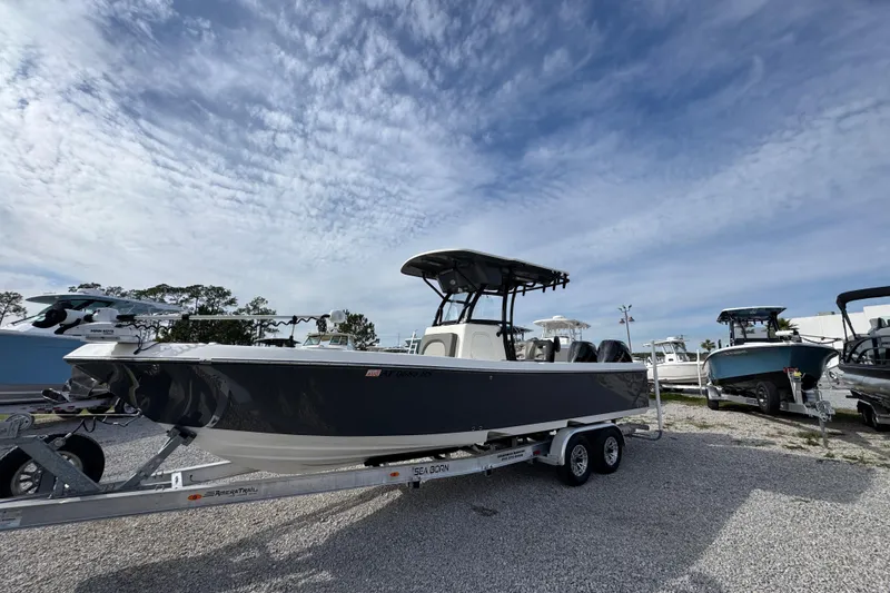 Slide: The Image of 2021 Sea Born LX26 Center Console boat on trailer under cloudy sky. - 3