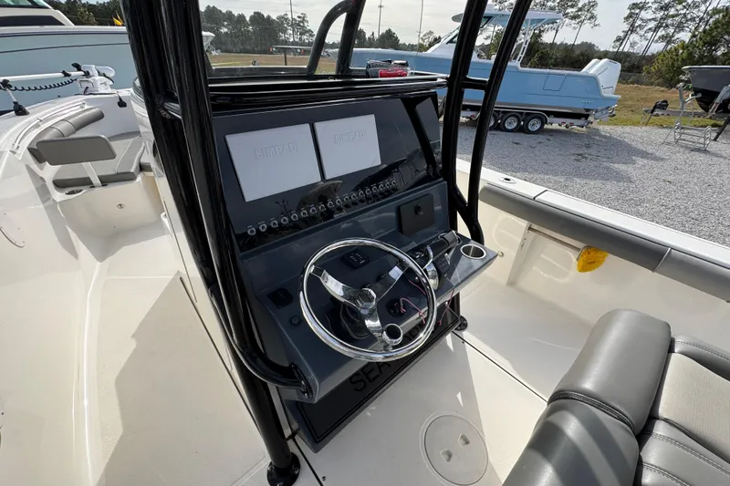 Slide: The Image of 2021 Sea Born LX26 Center Console boat interior with steering wheel and control panel. - 30