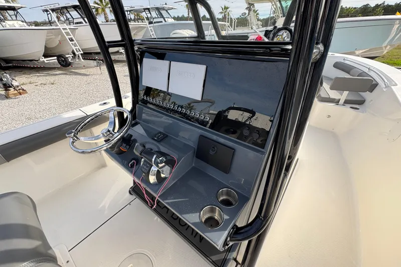 Slide: The Image of 2021 Sea Born LX26 Center Console boat interior with steering wheel and control panel. - 31