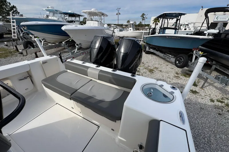 Slide: The Image of 2021 Sea Born LX26 Center Console boat with dual engines, parked on gravel lot. - 36