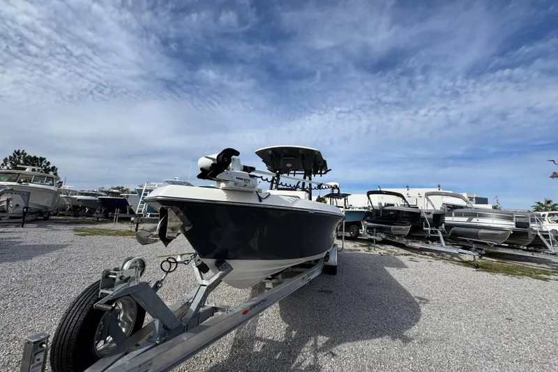 Slide: The Image of 2021 Sea Born LX26 Center Console boat on trailer under a cloudy sky. - 4