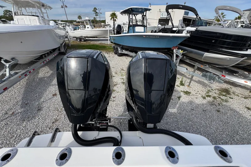 Slide: The Image of 2021 Sea Born LX26 Center Console with dual outboard motors in a boatyard. - 40
