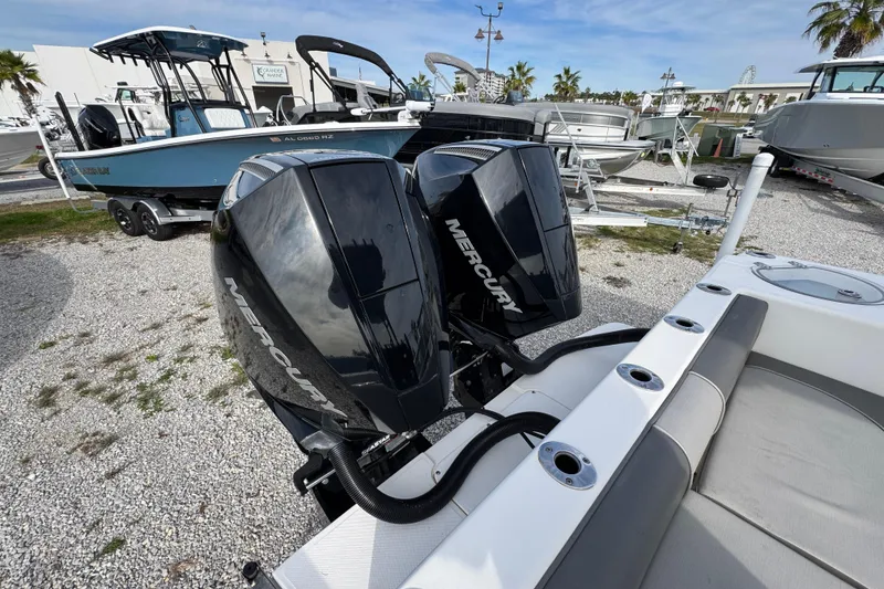 Slide: The Image of 2021 Sea Born LX26 Center Console with dual Mercury outboard engines in a boatyard. - 43