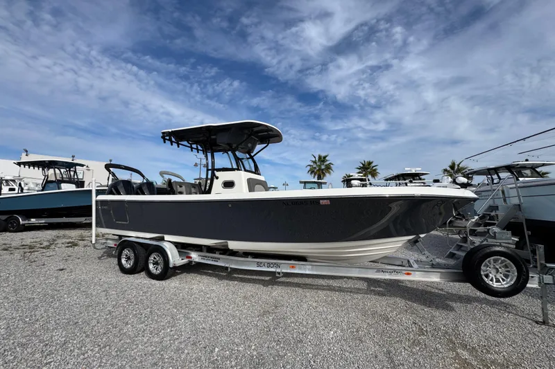 Slide: The Image of 2021 Sea Born LX26 Center Console boat on trailer under blue sky. - 8