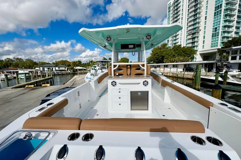 Slide: The Image of 2026 NauticStar 332 Offshore boat docked, featuring spacious deck and modern amenities. - 8