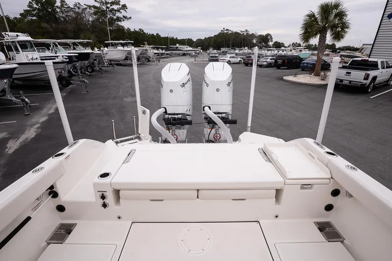 Slide: The Image of 2026 Solace 28 HCS boat with twin outboard engines in a marina setting. - 14
