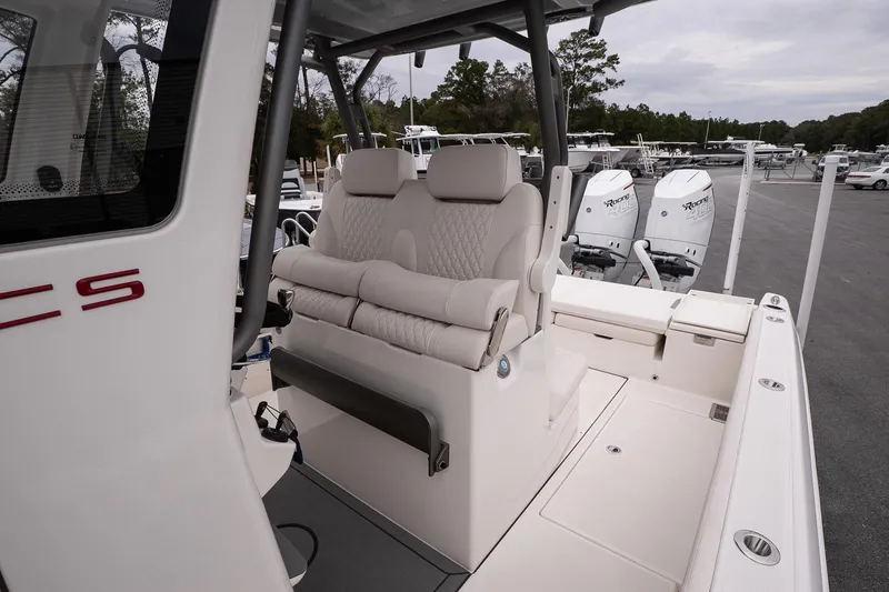 Slide: The Image of 2026 Solace 28 HCS boat interior with plush seating and dual outboard engines. - 18