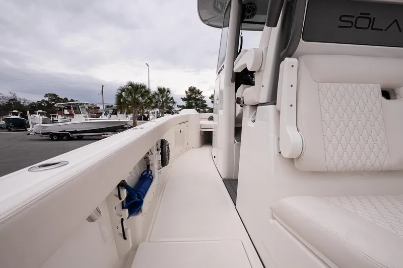 Slide: The Image of 2026 Solace 28 HCS boat interior with white seating and sleek design. - 21