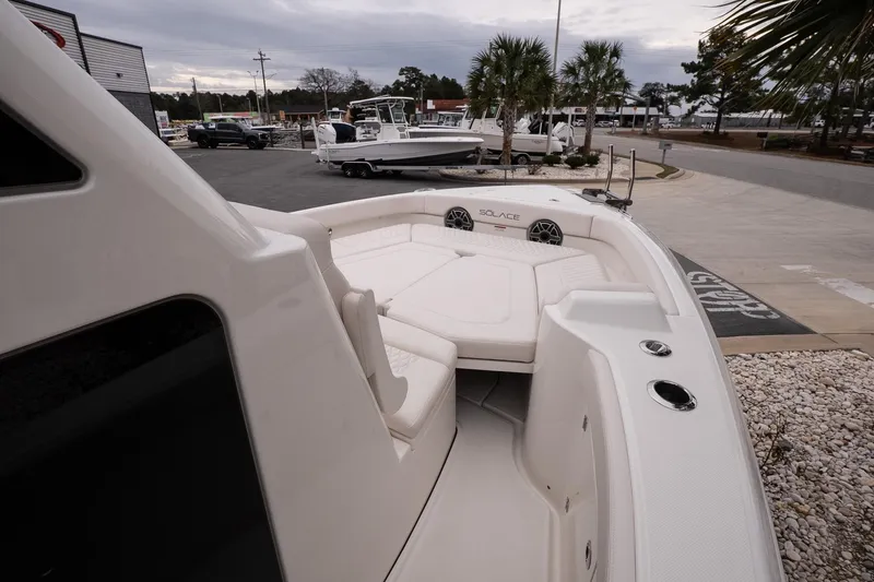 Slide: The Image of 2026 Solace 28 HCS boat with spacious seating, docked in a marina setting. - 23
