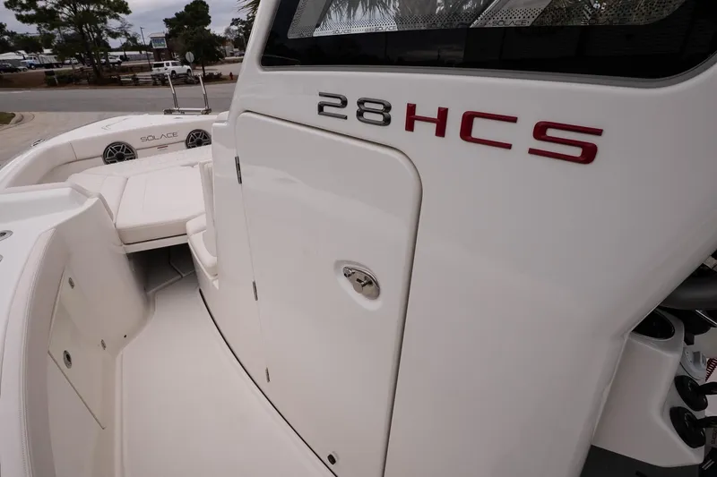 Slide: The Image of 2026 Solace 28 HCS boat interior with sleek white design and seating area. - 27