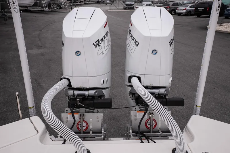 Slide: The Image of Twin outboard engines on a 2026 Solace 28 HCS boat, parked in a marina. - 29