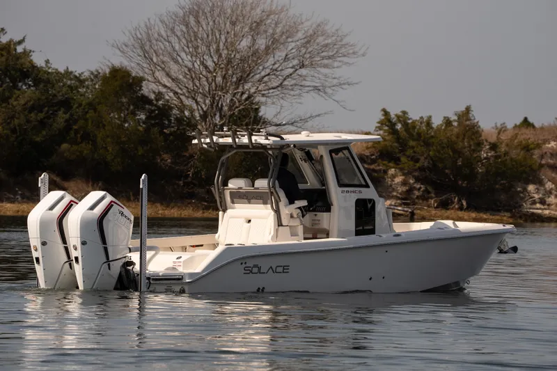 Slide: The Image of 2026 Solace 28 HCS boat on calm water, featuring dual engines and sleek design. - 38