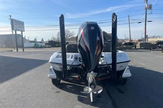 Slide: The Image of 2026 Ranger Z520 boat with powerful outboard motor in a parking lot. - 2