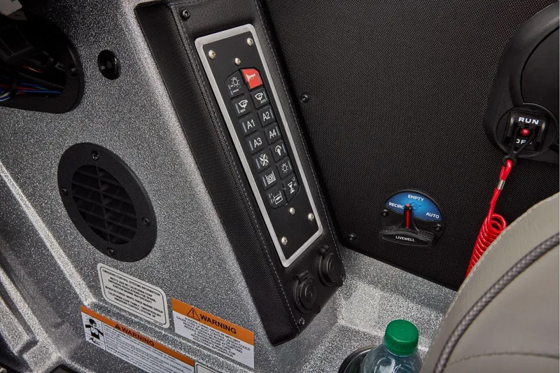 Slide: The Image of Manufacturer Provided Image: Control panel of 2026 Ranger Z520 boat with switches and warning labels. - 53