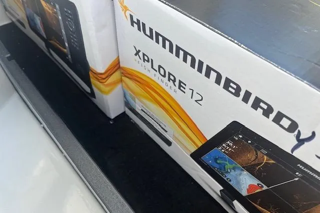 Slide: The Image of Boxes of Humminbird Xplore 12 fish finders inside a 2026 Ranger Z520 boat. - 89