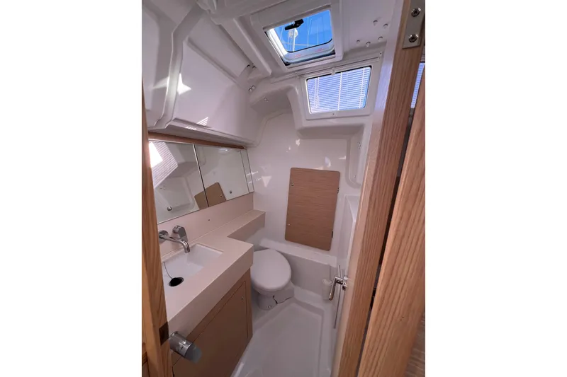 Slide: The Image of Modern bathroom interior of 2026 Dufour 37 yacht with skylight and wooden accents. - 12
