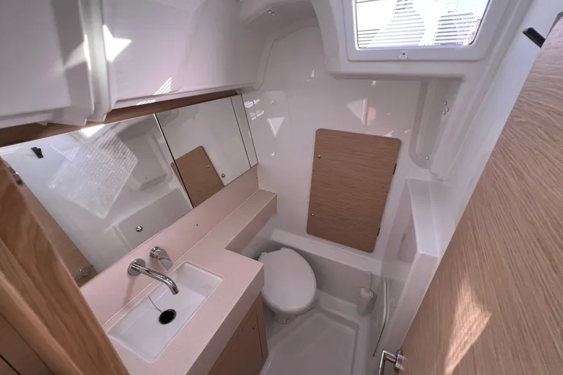 Slide: The Image of Modern bathroom interior of 2026 Dufour 37 yacht with sink, toilet, and mirror. - 13