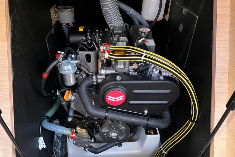 Slide: The Image of Engine compartment of 2026 Dufour 37 yacht, showcasing intricate mechanical components. - 14