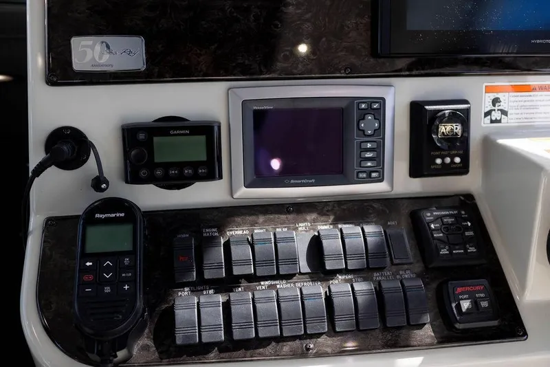 Slide: The Image of Control panel of a 2009 Searay 43 Sundancer boat with navigation and communication devices. - 12
