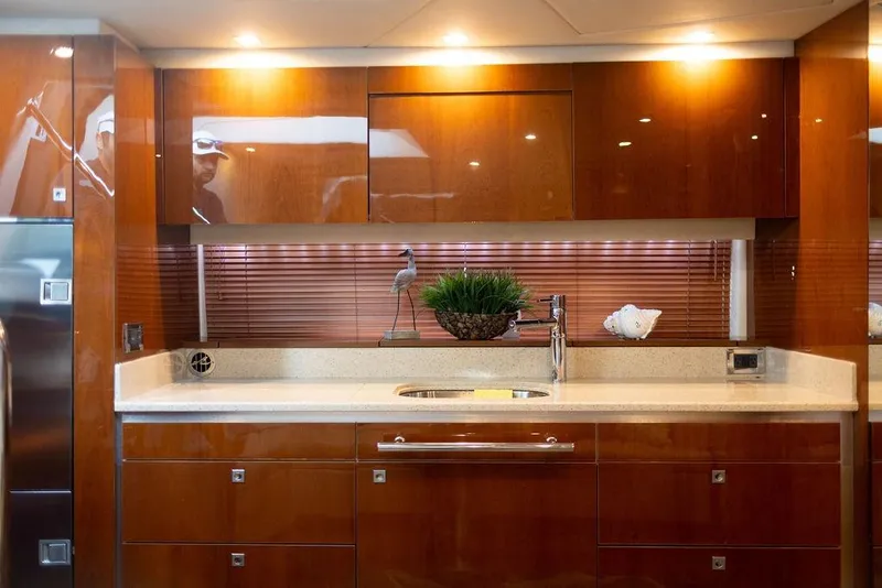 Slide: The Image of Luxurious kitchen interior of 2009 Searay 43 Sundancer yacht with sleek wooden cabinetry. - 14