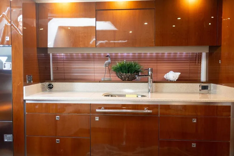 Slide: The Image of Luxurious kitchen interior of 2009 Searay 43 Sundancer yacht with sleek wooden cabinetry. - 16