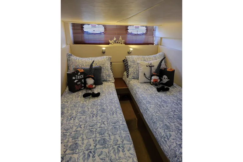 Slide: The Image of Cozy cabin with twin beds, nautical decor, and Halloween accents on 2009 Searay 43 Sundancer. - 26