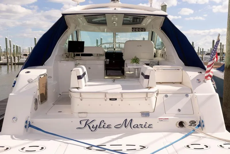 Slide: The Image of 2009 Searay 43 Sundancer yacht docked, featuring spacious seating and elegant design. - 3