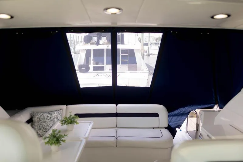 Slide: The Image of Interior of 2009 Searay 43 Sundancer yacht with white seating and potted plants. - 32